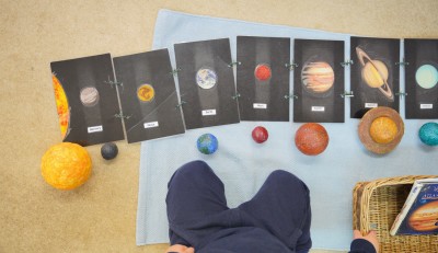 Early years Brookes student looking at planets