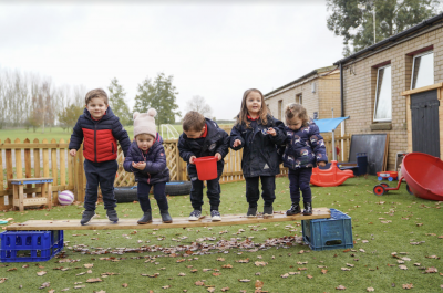 Five nursery children playing at Cherry Trees Nursery in Bury St Edmunds